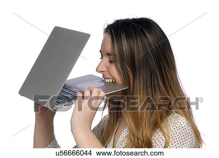 Young woman biting laptop. View Large Photo Image Picture - Young woman biting laptop.. Fotosearch