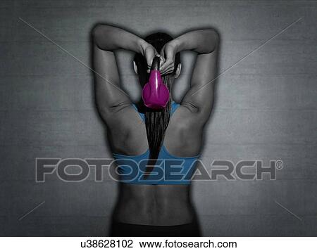 Young woman holding kettle bell, rear view. View Large Photo Image Stock Image - Young woman holding kettle bell, rear view.. Fotosearch