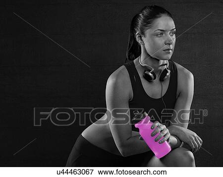 Young woman holding pink sports bottle, portrait. View Large Photo Image Stock Photo - Young woman holding pink sports bottle, portrait.. Fotosearch