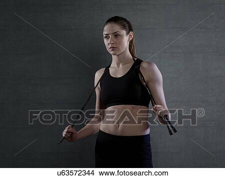 Young woman in sports top with skipping rope, portrait. View Large Photo Image Picture - Young woman in sports top with skipping rope, portrait.. Fotosearch