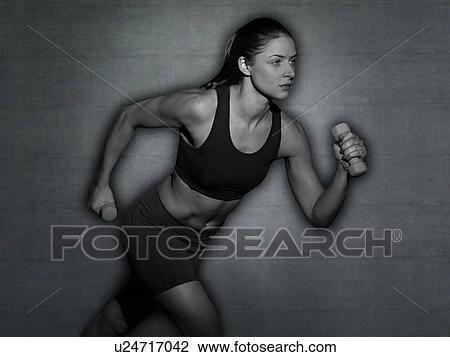 Young woman running with hand weights. View Large Photo Image Stock Image - Young woman running with hand weights.. Fotosearch