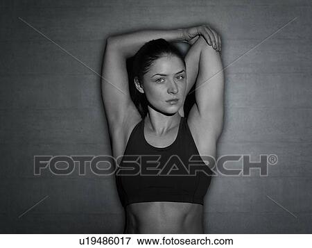 Young woman stretching arm, portrait. View Large Photo Image Stock Photo - Young woman stretching arm, portrait.. Fotosearch