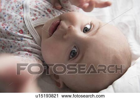 Stock Image - Baby girl (18-23 months) reaching camera. Fotosearch