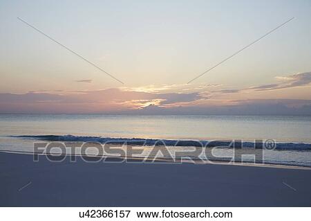Beach at sunset View Large Photo Image Stock Photo - Beach at sunset. Fotosearch