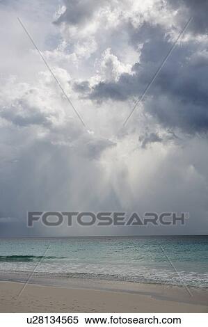 Beach under overcast sky View Large Photo Image Stock Photography - Beach under overcast sky. Fotosearch
