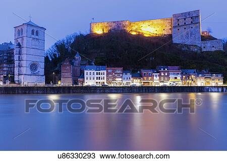 Stock Image - Belgium, Wallonia, Huy, Huy Citadel and Notre Dame Church at night. Fotosearch