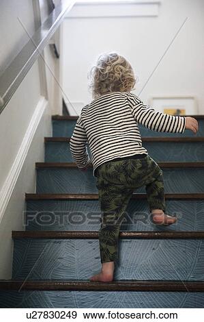 Stock Photo - Boy on staircase. Fotosearch