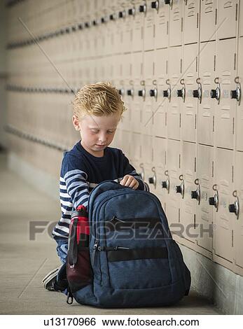 Boy with backpack by school lockers View Large Photo Image Stock Photograph - Boy with backpack by school lockers. Fotosearch