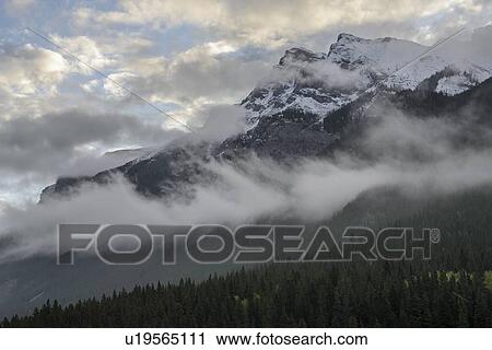 Canada, Alberta, Banff, Clouds over mountains View Large Photo Image Stock Image - Canada, Alberta, Banff, Clouds over mountains. Fotosearch