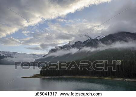 Stock Photo - Canada, Alberta, Banff, Clouds over mountains. Fotosearch
