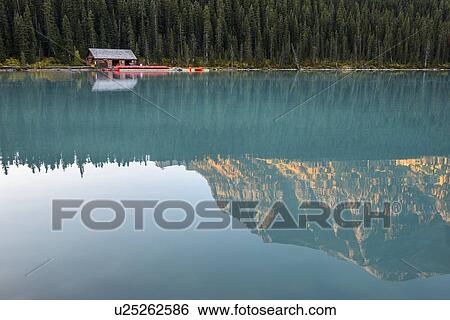 Canada, Alberta, Banff, Mountain and forest reflected in calm Lake Louise View Large Photo Image Stock Photograph - Canada, Alberta, Banff, Mountain and forest reflected in calm Lake Louise. Fotosearch