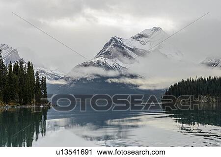 Canada, Alberta, Jasper, Mountains reflecting in Maligne Lake View Large Photo Image Stock Image - Canada, Alberta, Jasper, Mountains reflecting in Maligne Lake. Fotosearch