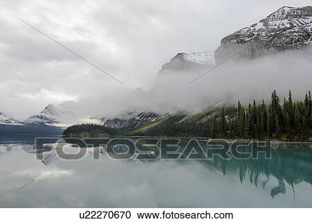 Canada, Alberta, Jasper, Mountains reflecting in Maligne Lake View Large Photo Image Stock Image - Canada, Alberta, Jasper, Mountains reflecting in Maligne Lake. Fotosearch