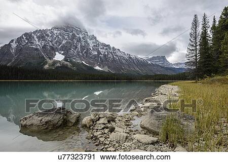 Canada, Alberta, Jasper, Mountains reflecting in lake View Large Photo Image Stock Image - Canada, Alberta, Jasper, Mountains reflecting in lake. Fotosearch