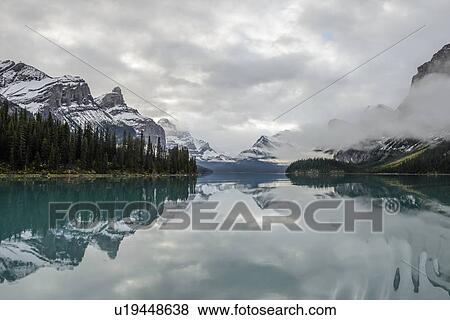 Canada, Alberta, Jasper, Mountains reflecting in Maligne Lake View Large Photo Image Stock Photo - Canada, Alberta, Jasper, Mountains reflecting in Maligne Lake. Fotosearch