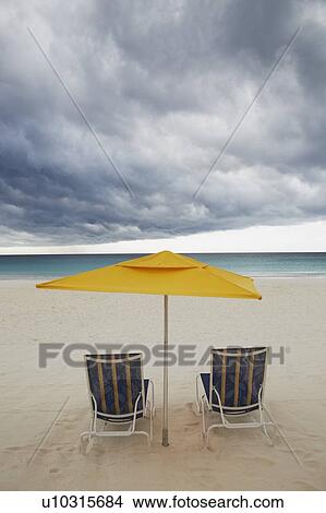 Picture - Chairs and umbrella on beach. Fotosearch