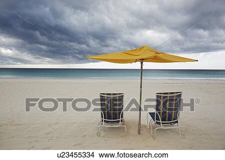 Chairs and umbrella on beach View Large Photo Image Picture - Chairs and umbrella on beach. Fotosearch