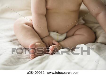 Close up of baby girl (12-17 months) in bed View Large Photo Image Stock Image - Close up of baby girl (12-17 months) in bed. Fotosearch
