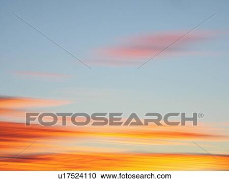 Stock Image - Clouds at sunset. Fotosearch