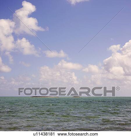 Stock Image - Cloudscape over sea. Fotosearch