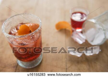 Cocktail in glass on wooden table View Large Photo Image Stock Image - Cocktail in glass on wooden table. Fotosearch