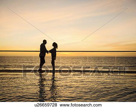 Couple at poolside over sea View Large Photo Image Stock Photo - Couple at poolside over sea. Fotosearch