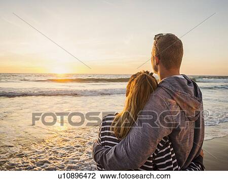 Couple looking at sunset View Large Photo Image Stock Image - Couple looking at sunset. Fotosearch