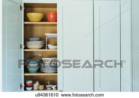 Dishes in cupboard View Large Photo Image Stock Image - Dishes in cupboard. Fotosearch