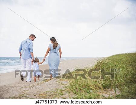 Family holding hands on beach View Large Photo Image Stock Photo - Family holding hands on beach. Fotosearch