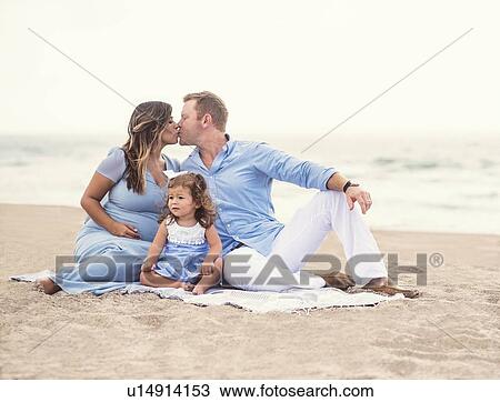 Family sitting on blanket on beach View Large Photo Image Stock Image - Family sitting on blanket on beach. Fotosearch