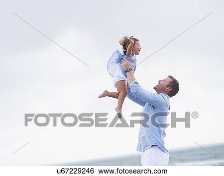 Father lifting daughter View Large Photo Image Stock Photograph - Father lifting daughter. Fotosearch