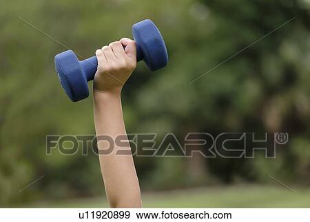 Female hand lifting dumbbell View Large Photo Image Stock Photo - Female hand lifting dumbbell. Fotosearch