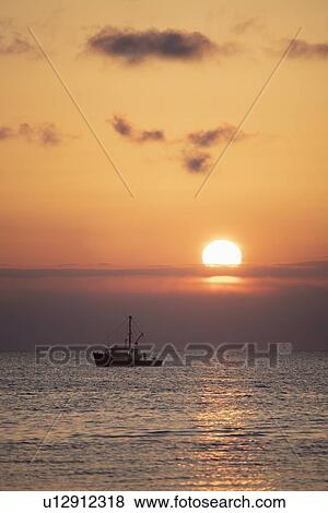 Fishing boat at sunset View Large Photo Image Stock Photo - Fishing boat at sunset. Fotosearch