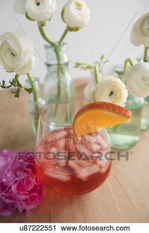 Flowers and drink on wooden table View Large Photo Image Stock Image - Flowers and drink on wooden table. Fotosearch