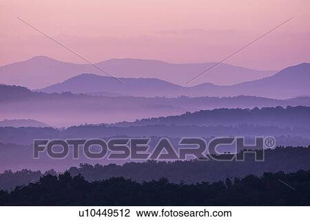 Stock Image - Fog at sunrise in Blue Ridge Mountains. Fotosearch