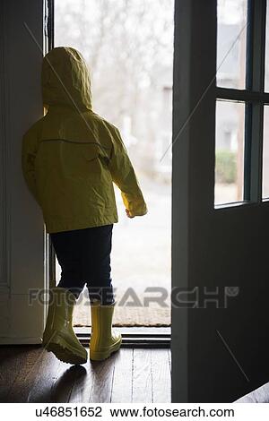 Girl (2-3) in rubber boots and rain cape standing at open door View Large Photo Image Stock Image - Girl (2-3) in rubber boots and rain cape standing at open door. Fotosearch