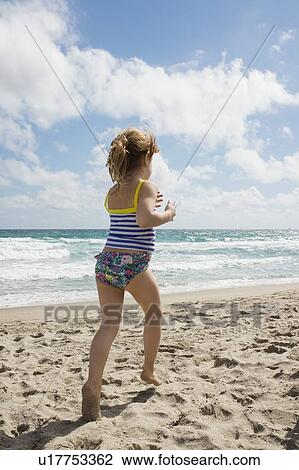 Girl running on beach View Large Photo Image Stock Image - Girl running on beach. Fotosearch