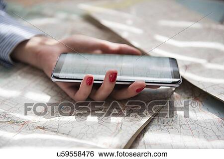 Stock Photograph - Hand of woman holding smartphone. Fotosearch