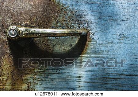 Stock Image - Handle on rusty car door. Fotosearch