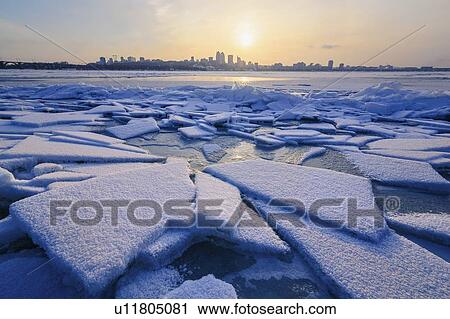 Stock Image - Ice on river at sunset. Fotosearch