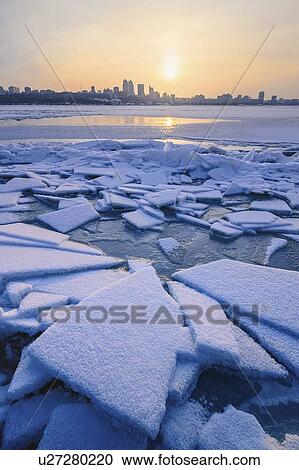 Stock Image - Ice on river at sunset. Fotosearch
