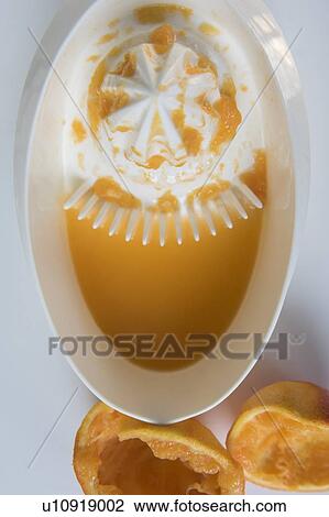 Stock Image - Juicer and oranges. Fotosearch