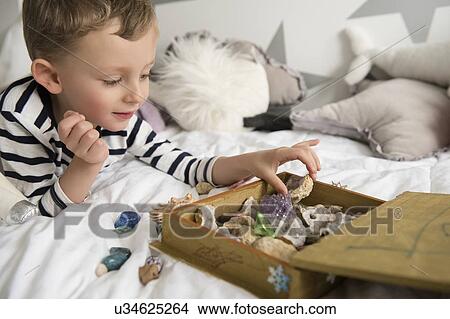 Picture - Little boy (4-5) with box full of treasures. Fotosearch