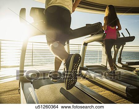 Man and woman exercising on patio over sea View Large Photo Image Picture - Man and woman exercising on patio over sea. Fotosearch