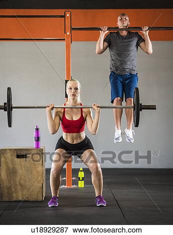Stock Photo - Man and woman working out. Fotosearch
