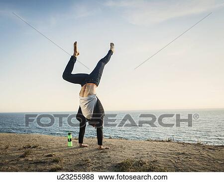 Man doing handstand on beach View Large Photo Image Stock Photo - Man doing handstand on beach. Fotosearch