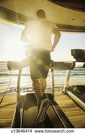 Man exercising on patio over sea View Large Photo Image Picture - Man exercising on patio over sea. Fotosearch