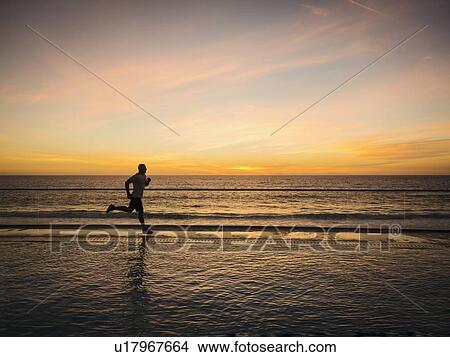 Man jogging along poolside View Large Photo Image Picture - Man jogging along poolside. Fotosearch