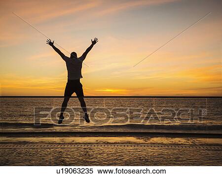 Man jumping at poolside View Large Photo Image Stock Photography - Man jumping at poolside. Fotosearch