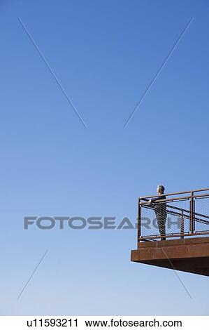 Stock Image - Man on observation deck. Fotosearch
